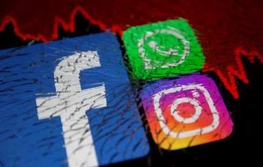 FILE PHOTO: Facebook, Whatsapp and Instagram logos and stock graph are displayed through broken glass in this illustration