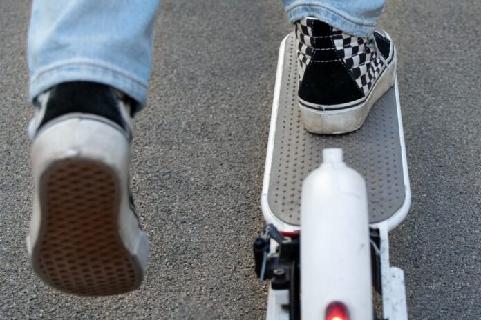 back-view-young-person-electric-scoote8.e323f7