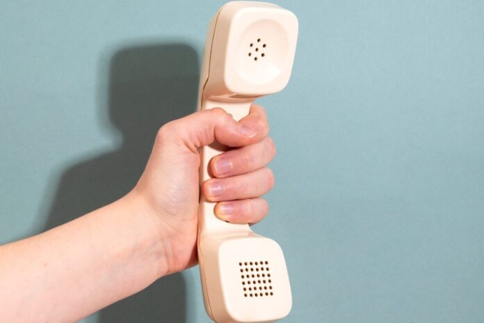 hand-holding-phone-with-blue-background